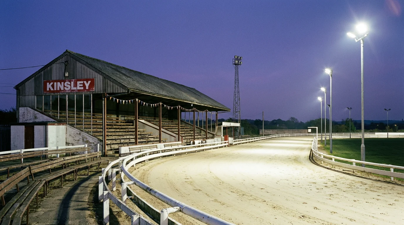Kinsley greyhound stadium under evening floodlights with the sand track and grandstand